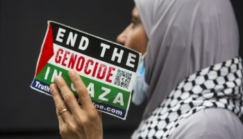 Protestors gather outside the Israeli embassy on O’Connor street in downtown Ottawa on July 30, 2025, to call on the Israeli government to end its genocide in Gaza. The Hill Times photograph by Andrew Meade
